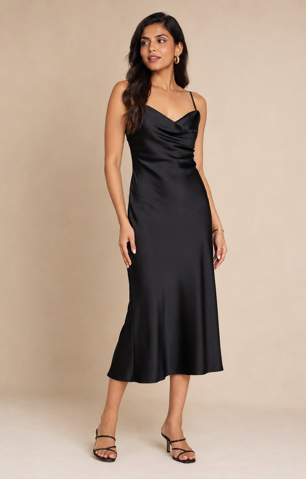 Women wearing a black satin cowl-neck midi dress